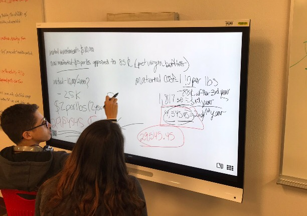 Students working at a Smartboard